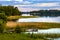 Jezioro Selmet Wielki lake landscape with vintage pier reeds and wooded shoreline in Sedki village in Masuria region of Poland