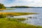 Jezioro Selmet Wielki lake landscape with vintage pier reeds and wooded shoreline in Sedki village in Masuria region of Poland