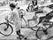 Jhargram, West Bengal, India - May 05, 2019: Black and white image of A hand pulled rickshwa was pulled by someone on a busy road