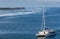 Ji Pantai Serangan beach and sail boat outside Benoa Harbor in Bali, Indonesia