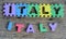 Jigsaw written Italy word on wood background