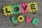 Jigsaw written love word on wood background