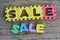 Jigsaw written sale word on wood background