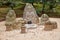 Jizo Buddhist images and coins that visitors tossed. Kinkaku-ji temple. Kyoto. Japan