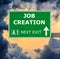 JOB CREATION road sign against clear blue sky