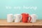 Job recruit concept with coffee cups and text `We are hiring`. Business background