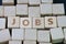 Job recruitment, career vacancy or hiring position in the company concept, cube wooden block with alphabet combine the word Jobs