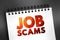 Job scams text quote on notepad, concept background