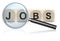 Job search - magnifying glass enlarges word JOBS