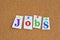 Jobs and career concept with colorful paper pins on billboard