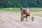 A jockey on a chariot with a horse does a warm-up warm-up before the race