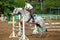 Jockey in glasses jump on horse