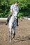 Jockey in glasses riding horse