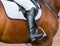 Jockey riding boot in the stirrup