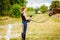 Jockey young woman getting horse ready for ride