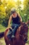 Jockey young woman getting horse ready for ride