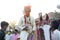 Jodhpur, Rajashtbn, India. 30 June 2020: Indian groom wearing protective mask with sword in hand sitting on horse, baarat lock