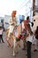 Jodhpur, Rajashtbn, India. 30 June 2020: Indian groom wearing protective mask with sword in hand sitting on horse, baarat lock