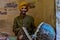 Jodhpur, Rajasthan, India, 2020. Traditional Rajasthani drum player wearing yellow pagdi playing drums in Mehrangarh Fort
