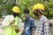 Jodhpur, rajasthan, india, 20th September 2020: young indian civil engineers describing work blueprint to focused workers all