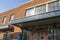 Joeâ€™s Crab Shack along River Street in a red brick buildings with windows and a statue of ships captain in the front