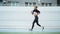 Jogger with artificial limb training on running surface. Athlete training cardio