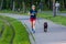 Jogger and her dog runs along the Lake of the Isles trail in Minneapolis