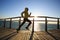 Jogger morning exercise on seaside boardwalk