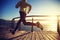 Jogger morning exercise on seaside boardwalk during sunrise