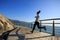 Jogger morning exercise on seaside boardwalk during sunrise