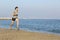 Jogger running on the beach near the water