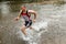 Jogger running through a streambed