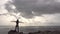 Jogger woman raise hands standing on rock near ocean