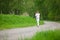 Jogging - sportive woman running on road in nature