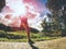 Jogging tall sports man in trees shadows with sun light behind