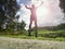 Jogging tall sports man in trees shadows with sun light behind