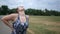 A jogging woman experiences lower back pain during a run in a park