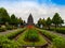 JOGJA, INDONESIA - AUGUST 12, 2O17: Unidentified people walking near of a beautiful jarden with a Prambanan temple in