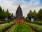 JOGJA, INDONESIA - AUGUST 12, 2O17: Unidentified people walking near of a beautiful jarden with a Prambanan temple in