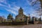 Johannes de Doper church with its bell tower and surrounded by tombs