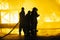 JOHANNESBURG, SOUTH AFRICA - MAY, 2018 Group of firefighters standing in front of fire during fighting training exercise