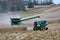 John Deer 8R340 tractor pulling a Brent 1196 grain cart while transfering corn from a John Deer S780 harvester