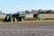 John Deer 9220 tractor pulling a Brent 1194 grain cart and a John Deer S670 harvester
