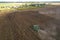 John Deere combine harvester working on harvesting rapeseed. Farm Harvest season in rural. Harvester for agriculture work.