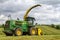 John Deere Forage Harvester with rows of grass
