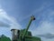 John Deere harvester works in the field. Combine Harvesting Wheat