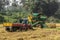 John Deere pick Thresher ready to unload in wagon, Hunumanahalli, Karnataka, India