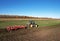 John Deere Tractor with disc cultivator  Vaderstad Top Down 500 on cultivating field. Agricultural tractor on cultivation field.