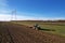 John Deere Tractor with disc cultivator  Vaderstad Top Down 500 on cultivating field. Agricultural tractor on cultivation field.