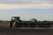 A John Deere Tractor with Great Plains Drills on the back planting a crop in Kansas in a farm field